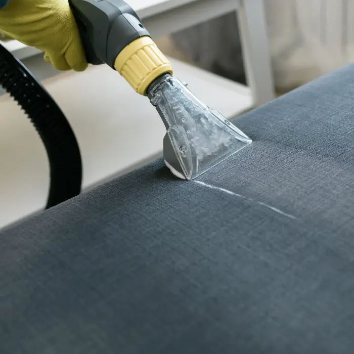 Upholstery cleaning vacuuming gray fabric